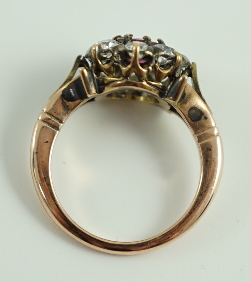 An antique gold, ruby and old cut diamond set circular cluster ring